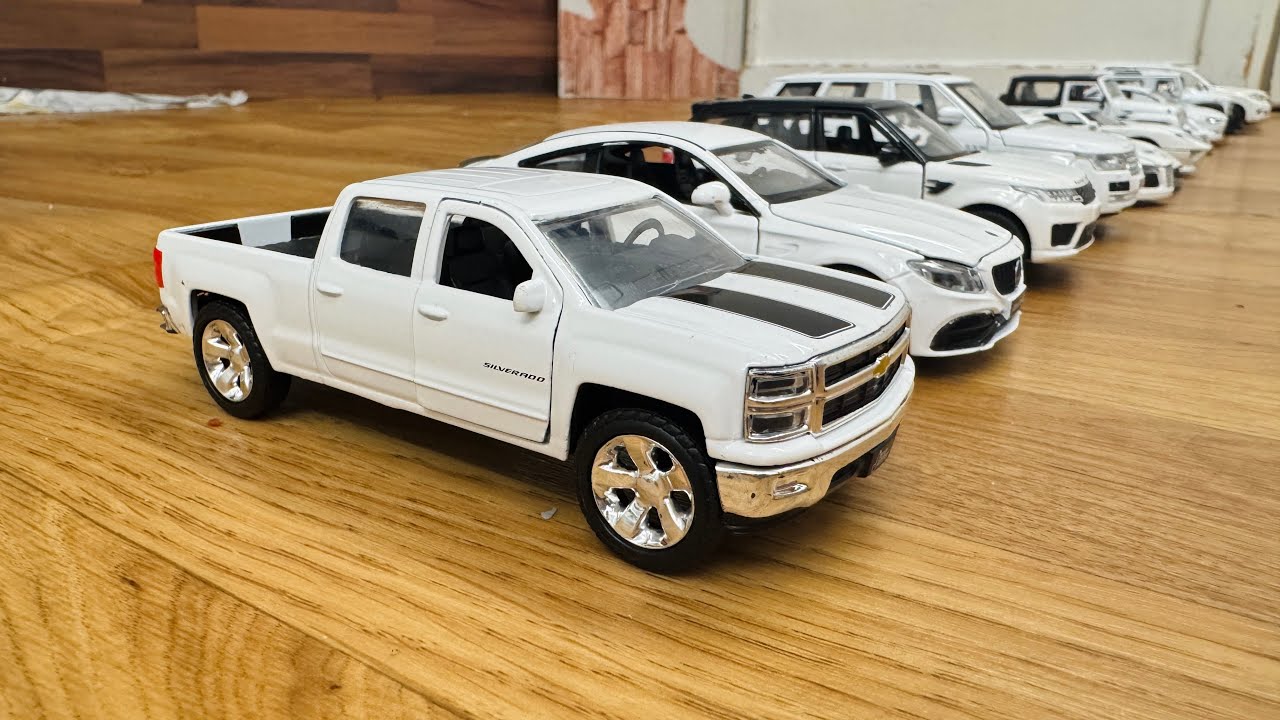 Various White Toy Cars Stopped By Hand While Moving