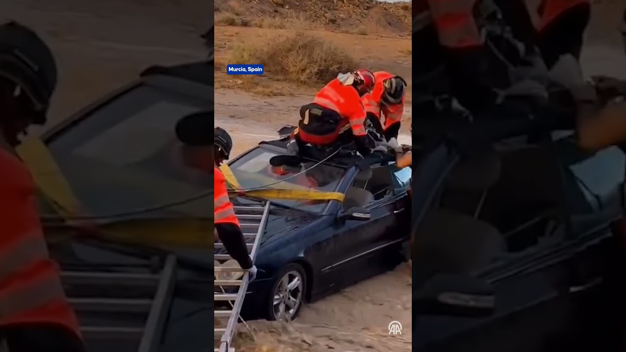 Dramatic rescue in Spain: Driver trapped inside car during floods pulled out as roof cut open