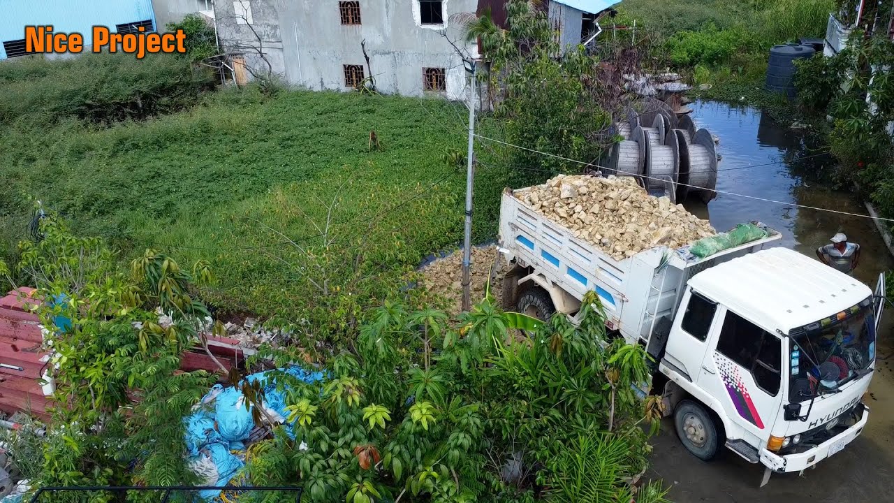 Good work good Action small space flooded land work by Bulldozer & 5T Truck to unloading stone