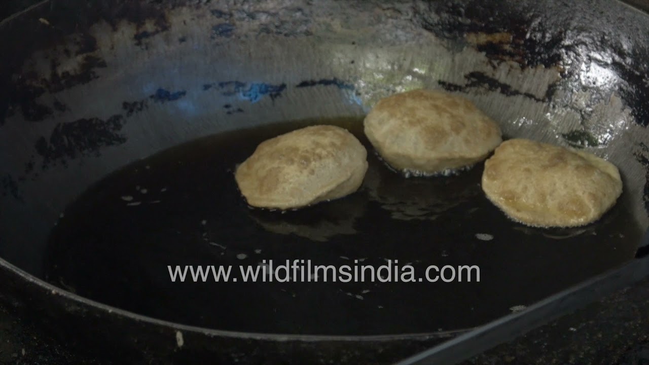 Cooking poori at Devender Tea Stall Hauz Khas Delhi’s beloved street food culture