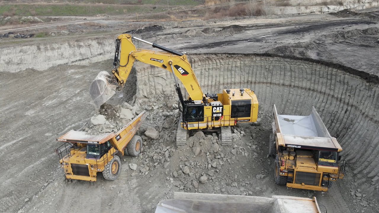 Huge Caterpillar 6015B Excavator Loading Caterpillar Dumpers - Sotiriadis Mining Works