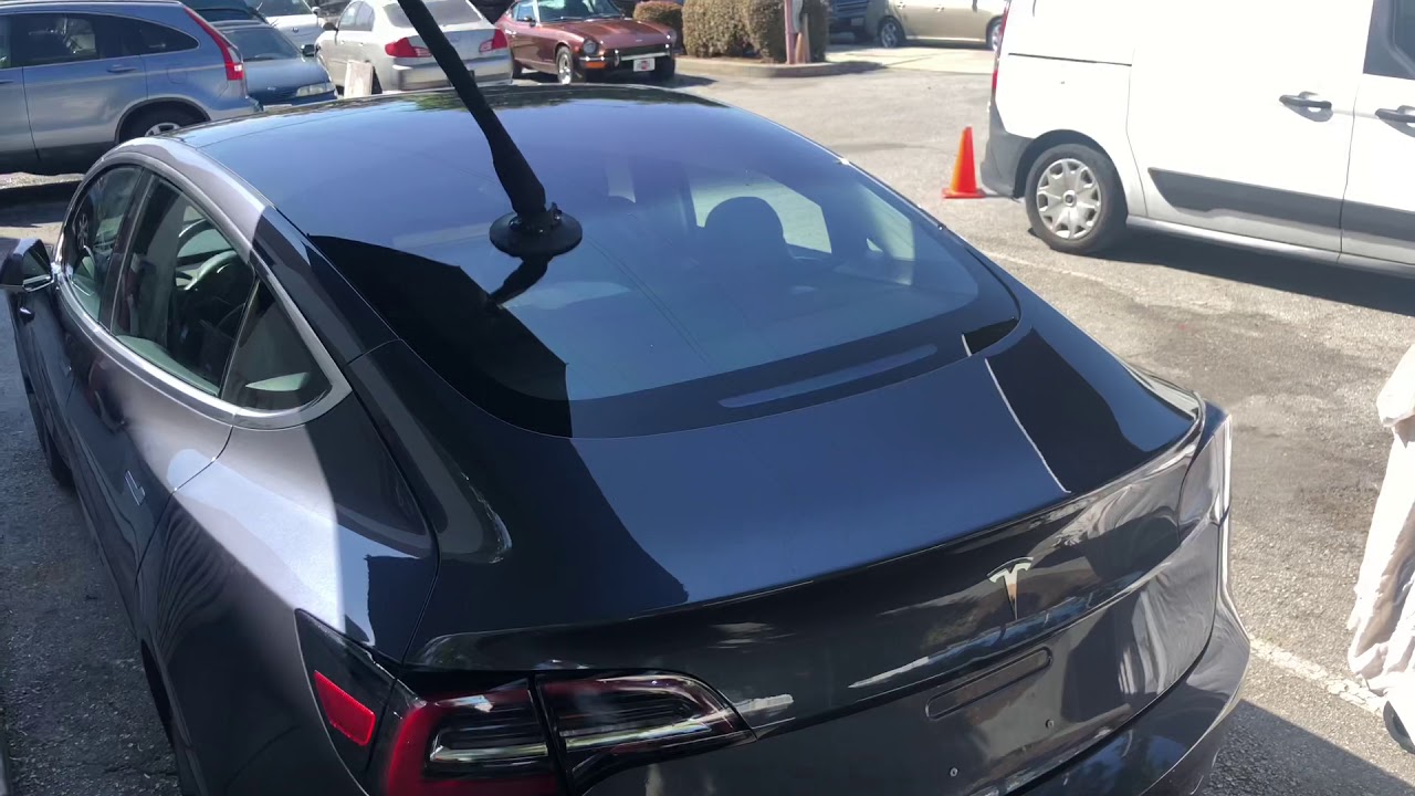 Tesla 3 trunk lid dent repaired without harm to the original paint.