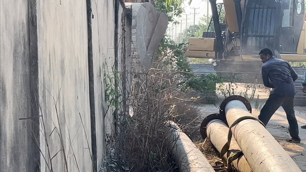 CAT Excavator Breaking Down Massive Wall