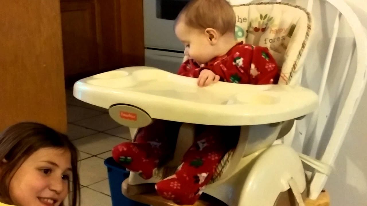 Baby playing peek a boo with big sister