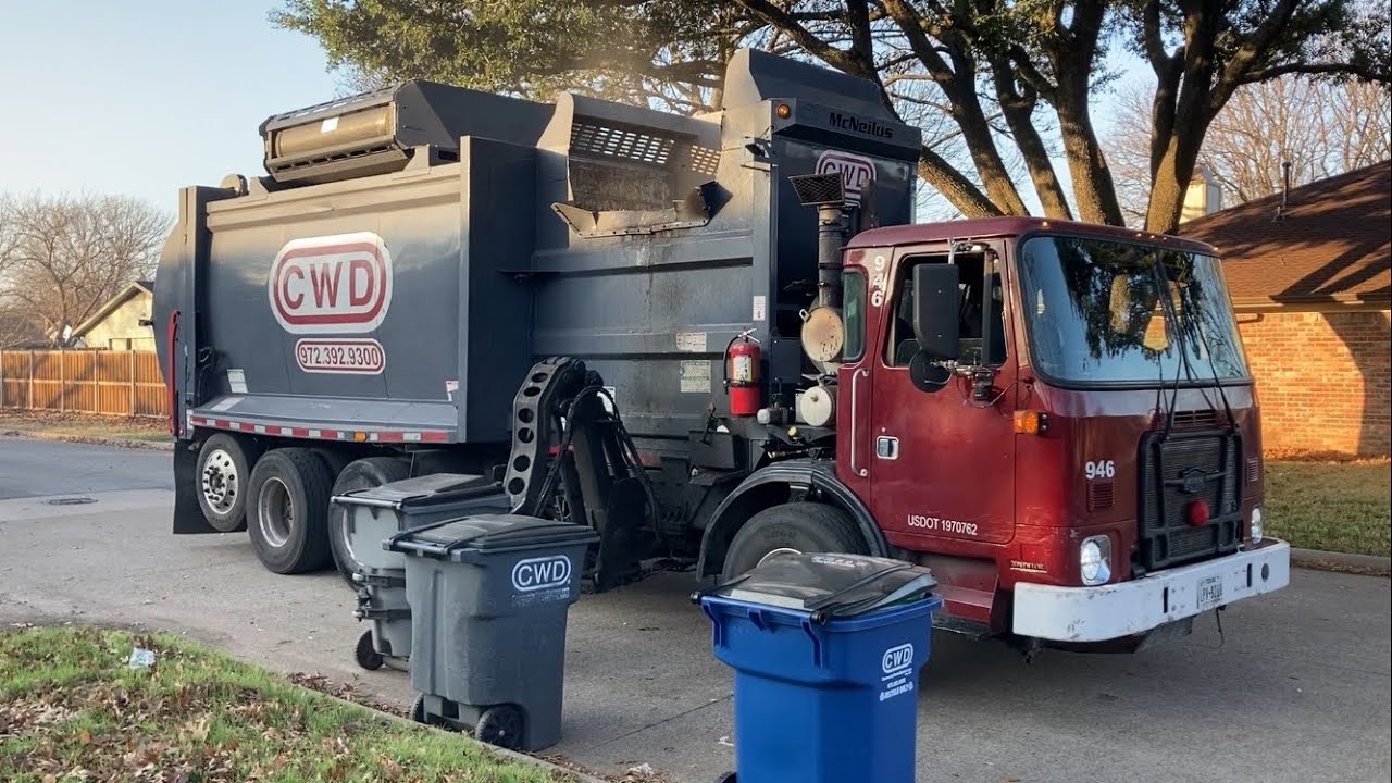 A Revving CWD Mcneilus Garbage Truck Collecting Trash