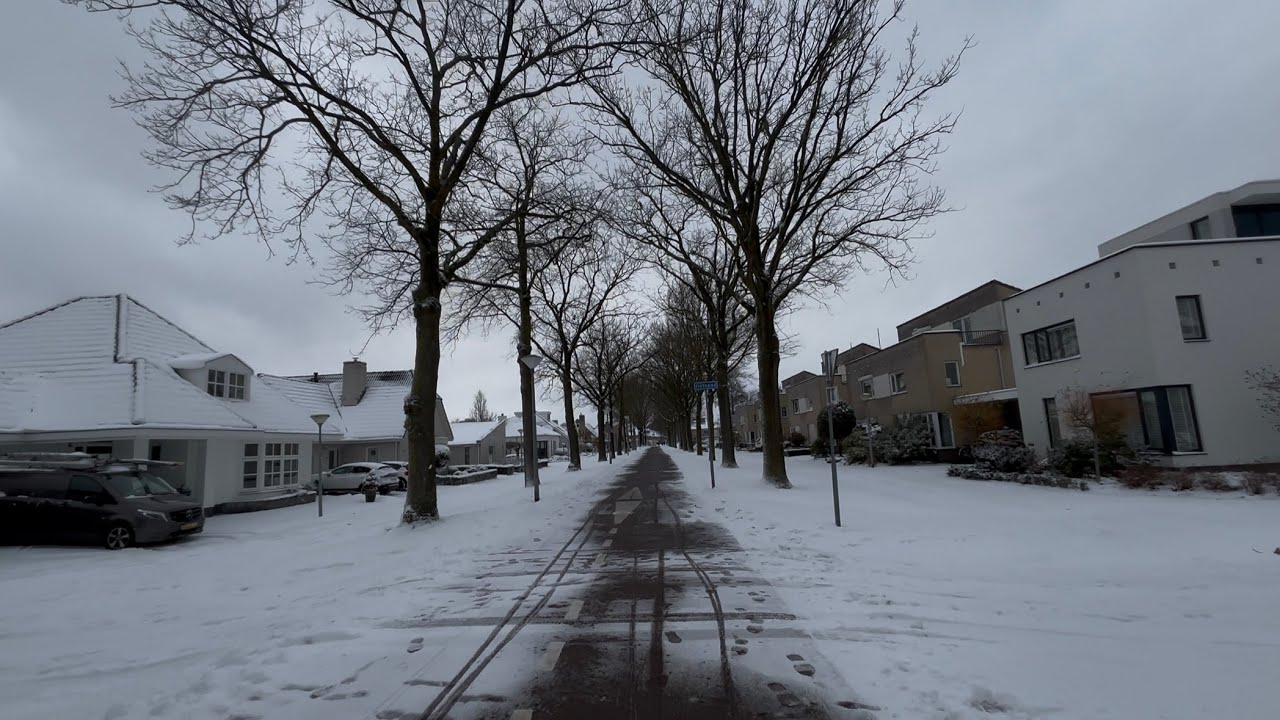 Cycling through a quaint Dutch town under snow