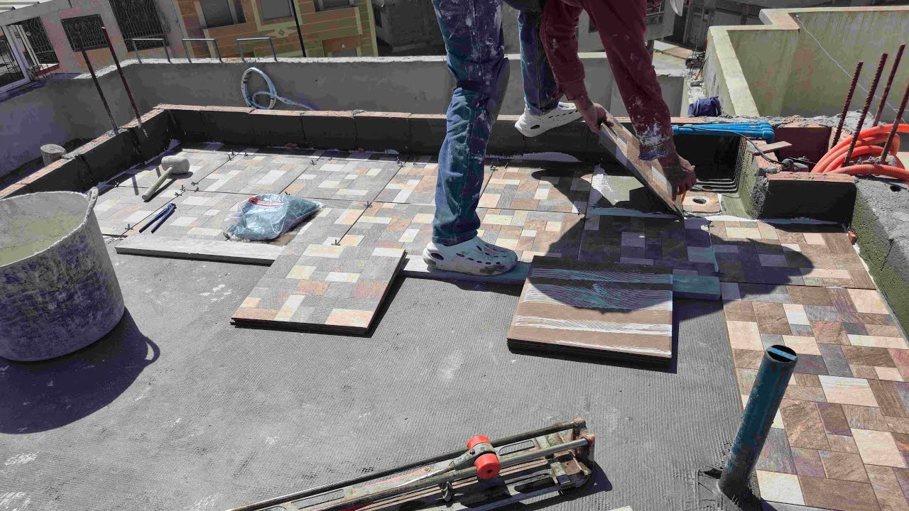 Installing ceramic floor tiles with adhesive
