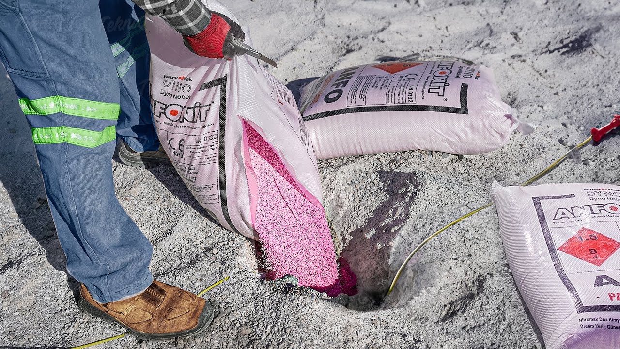 Charging a Big Hole With Pink Powder Before Blasting Inside Open Mine
