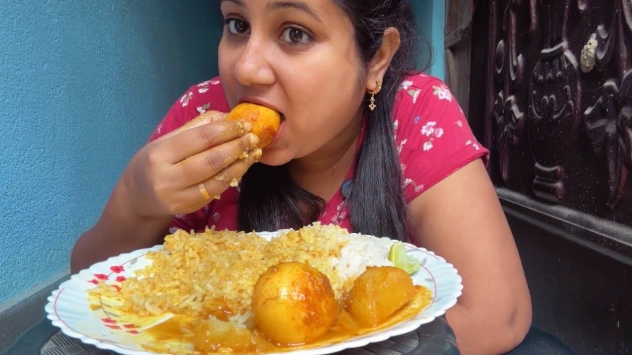 Eating egg curry with rice & raita 