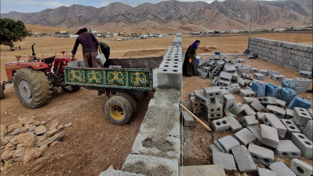 Tractor-hauling blocks to build a house for a homeless mother and her children in the plain