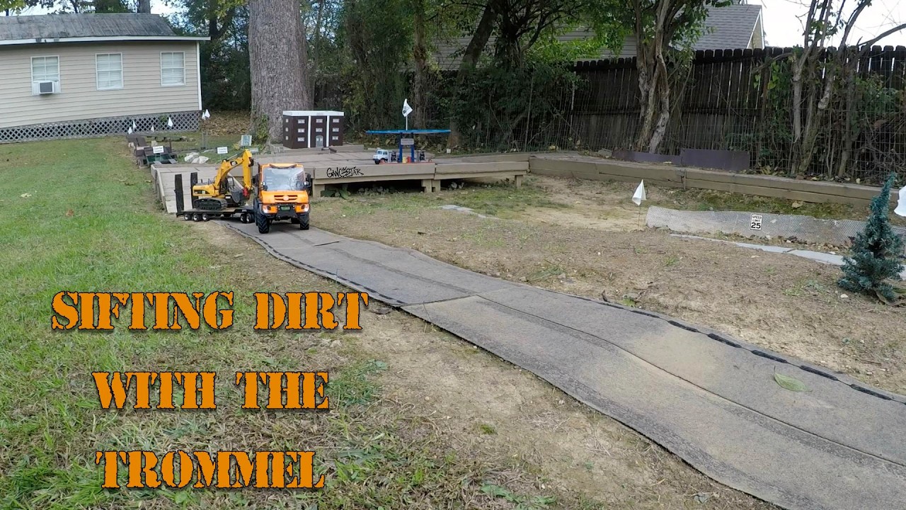 sifting dirt with the trommel and delivered to the job site. The foreman keeps an eye on us.