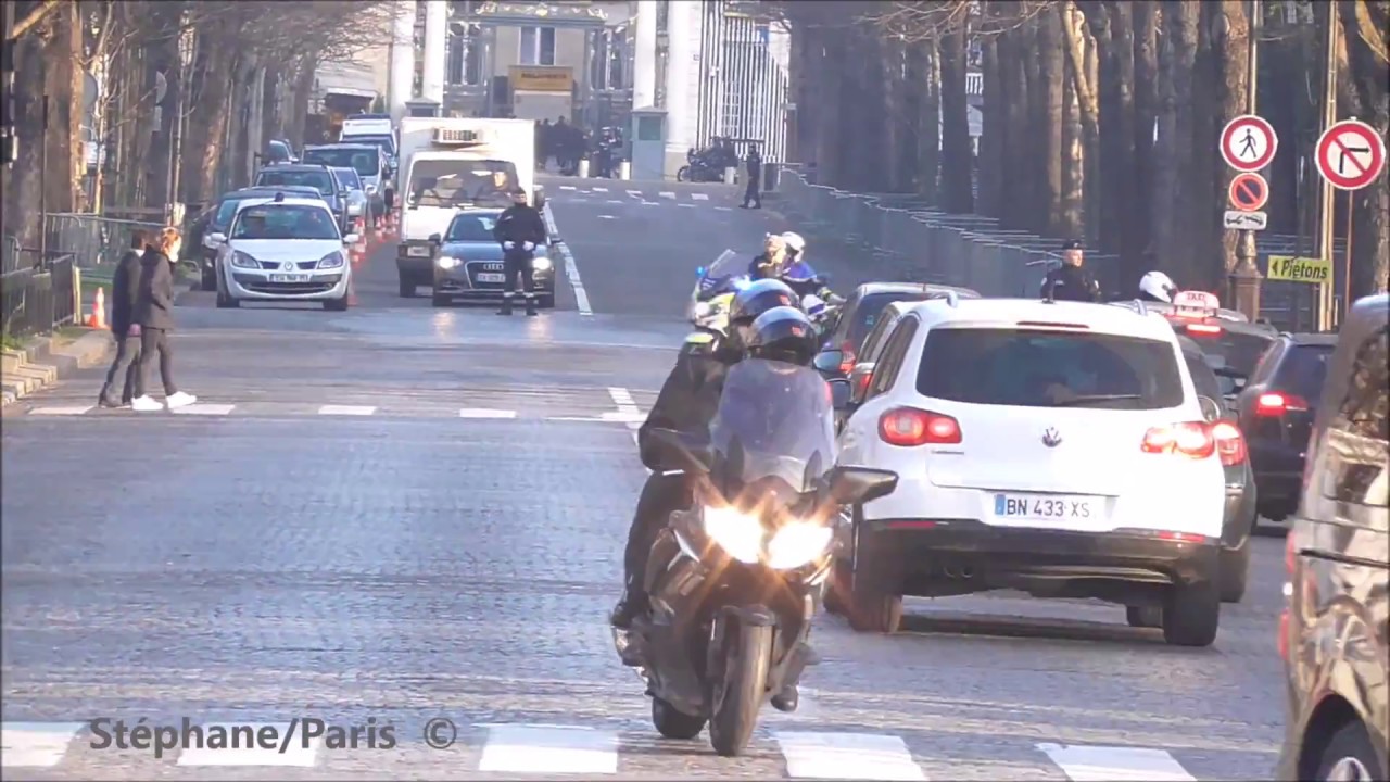 Motorcycle police escort the French President + a minister.
