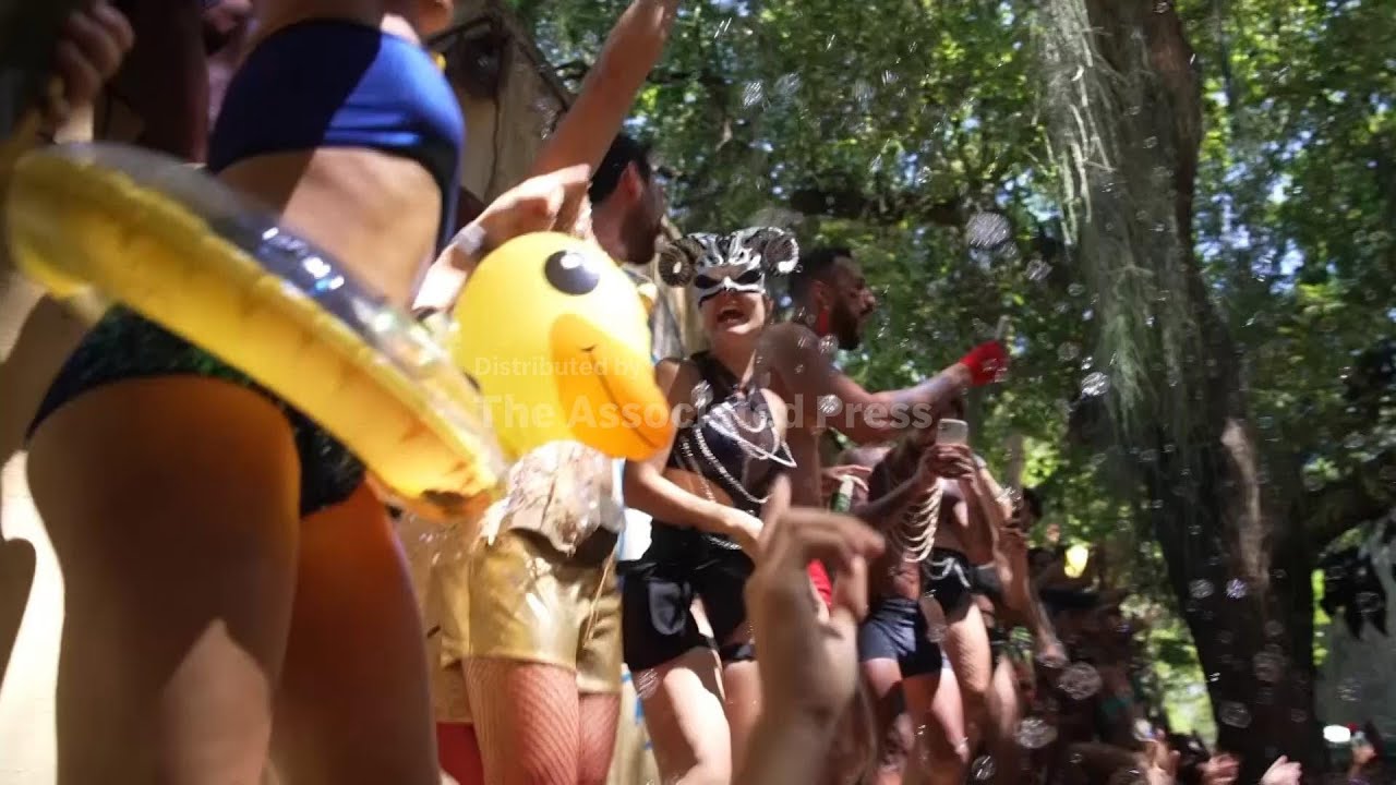 Revellers party through the streets of Rio de Janeiro ahead of Carnival