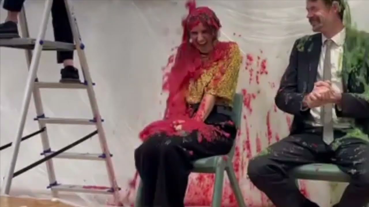 Beautiful teacher gets gunged for charity with red slime