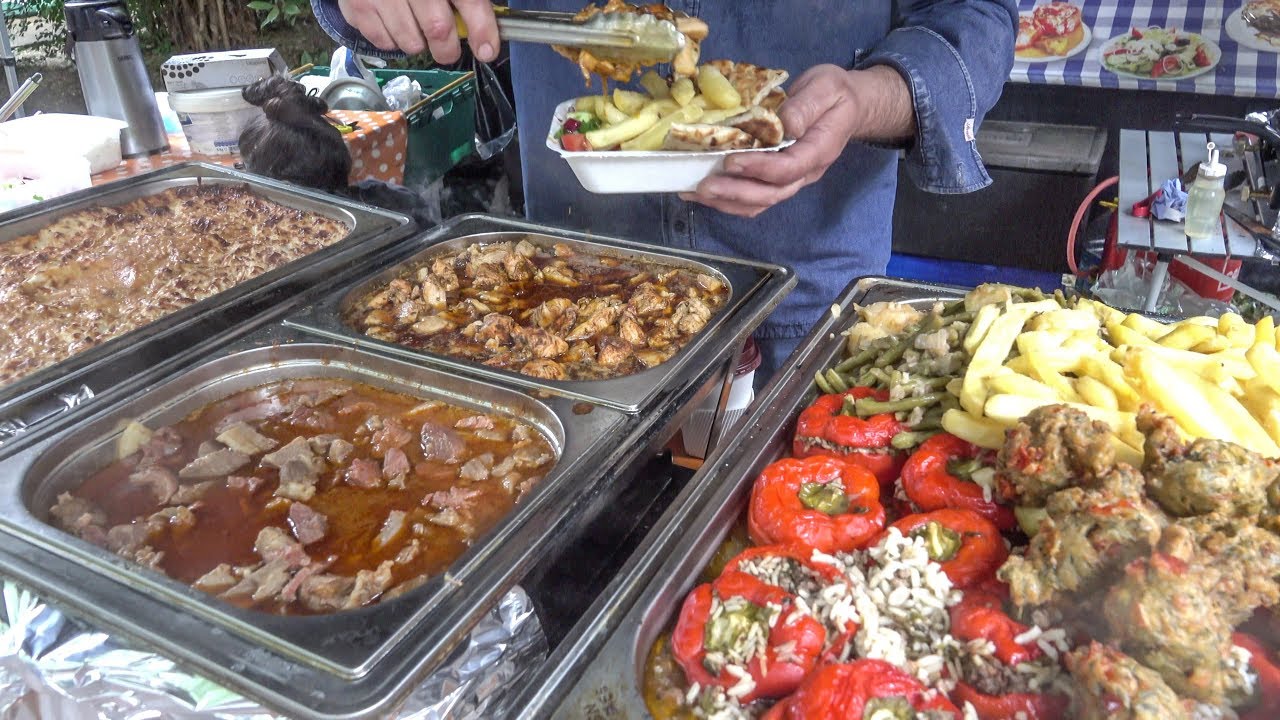Street food from Greece, Yummy and Colourful Fried Courgette Puffs, Tomatoes, Chicken and Meats