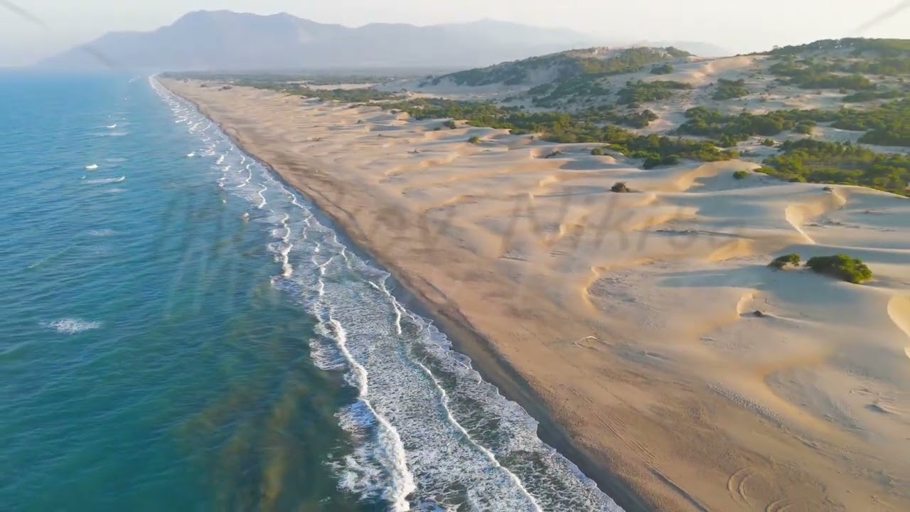 Gelemis, Turkey. Aerial view of long Patara Beach stretching to horizon with mountains, sand dune...