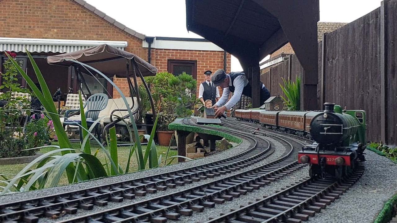 Family Create Miniature Railway In Garden
