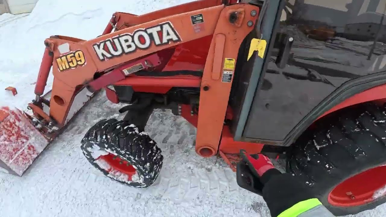 Snow plowing with a Kubota M59 Tractor