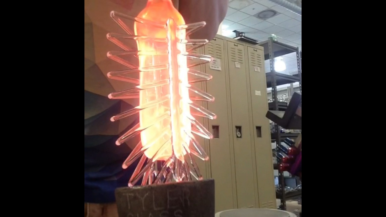Blowing glass into a lung shaped mold