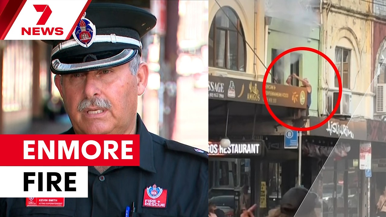 Neighbour climbs onto balcony to fight Sydney building fire | 7NEWS