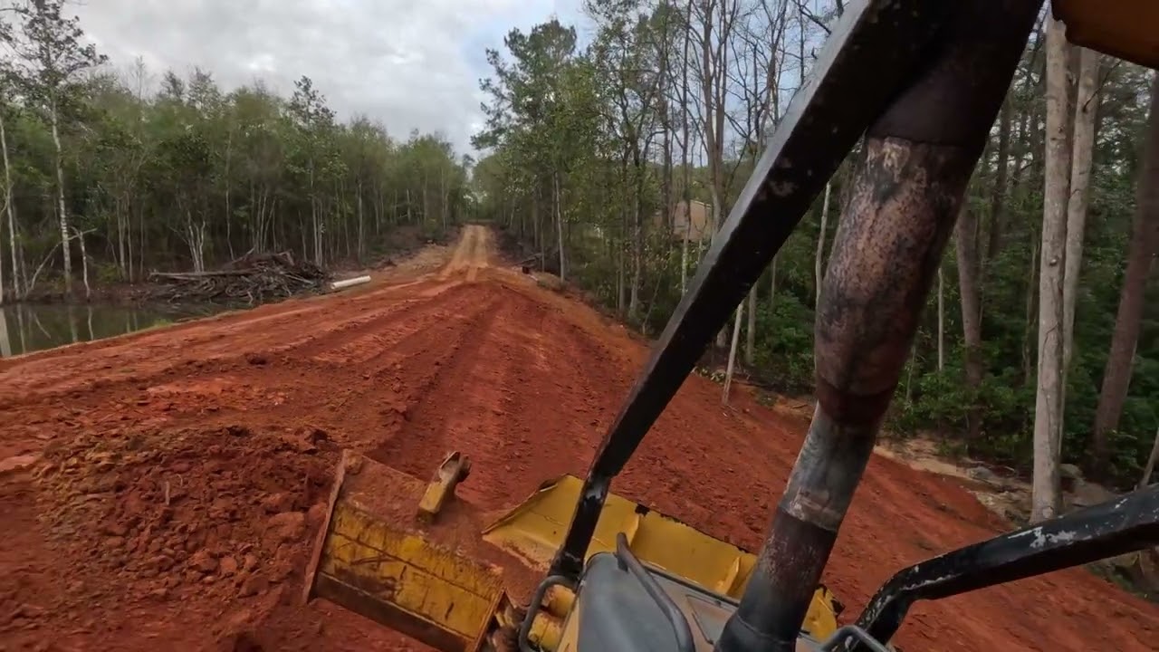 Finish grading a back slope repair on a pond dam .