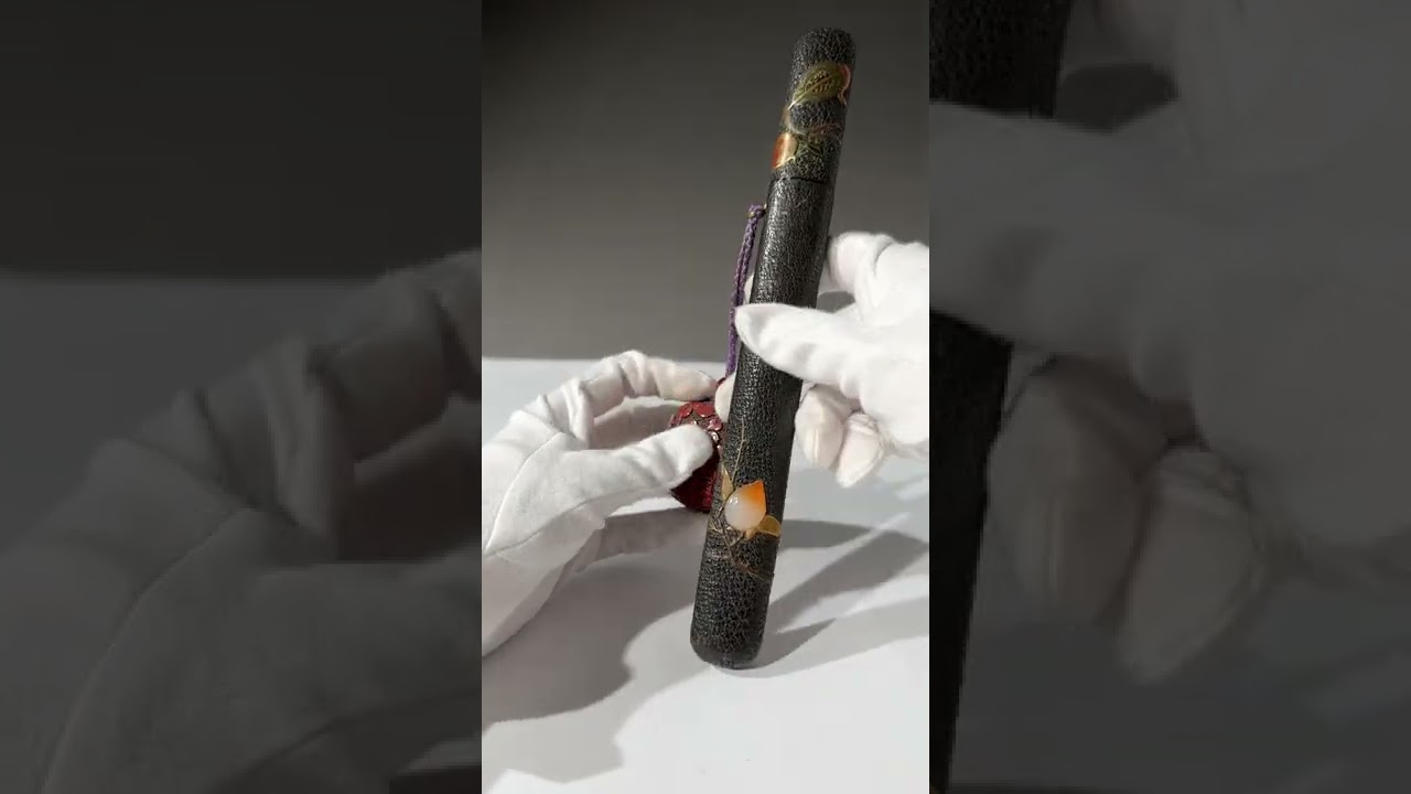 Lot 195 - A RARE YATATE WITH LACQUERED LEATHER FUDEZUTSU AND TSUISHU &lsquo;INRO&rsquo; SUMITSUBO
