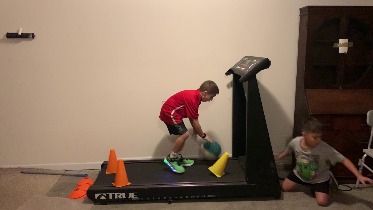 Basketball-Mad Kid Trains Dribbling Skills on a Treadmill in Atlanta