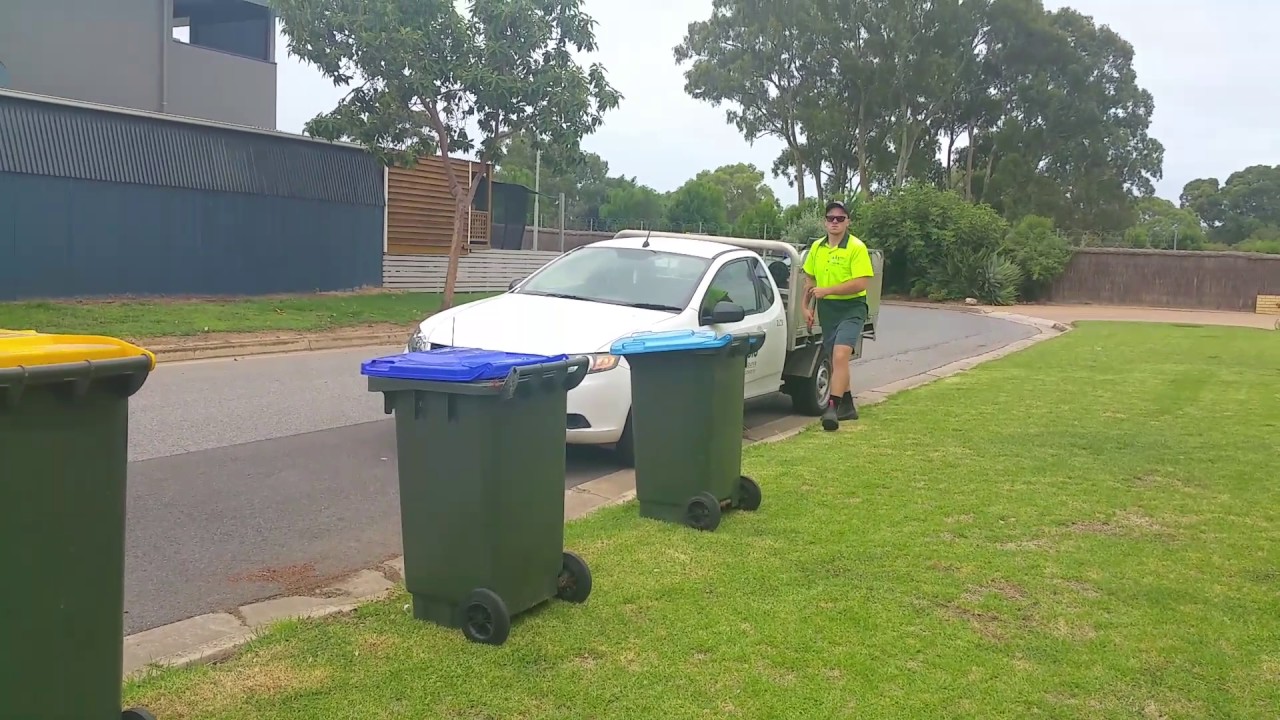 Government people fix garbage bin