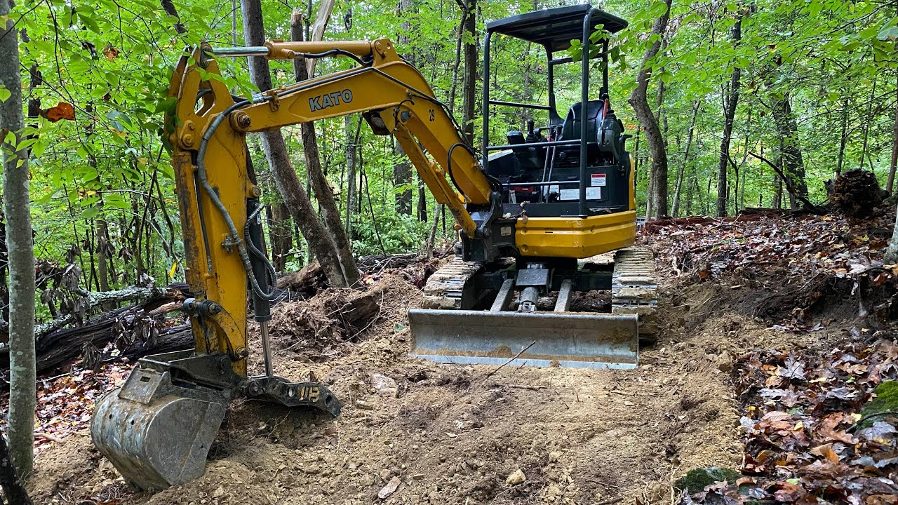 Mini Excavator trail building in less then perfect conditions & Trucking with an International 4900