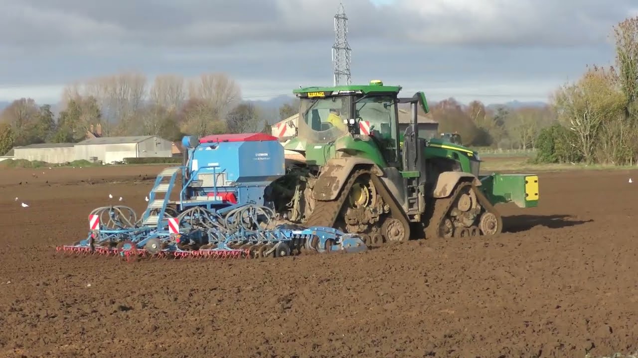 Four John Deere tractors drilling winter wheat