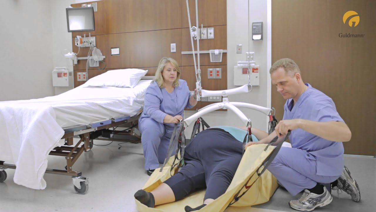 Guldmann Ceiling Lift: Bariatric Repositioning Sling - Lifting from floor to bed