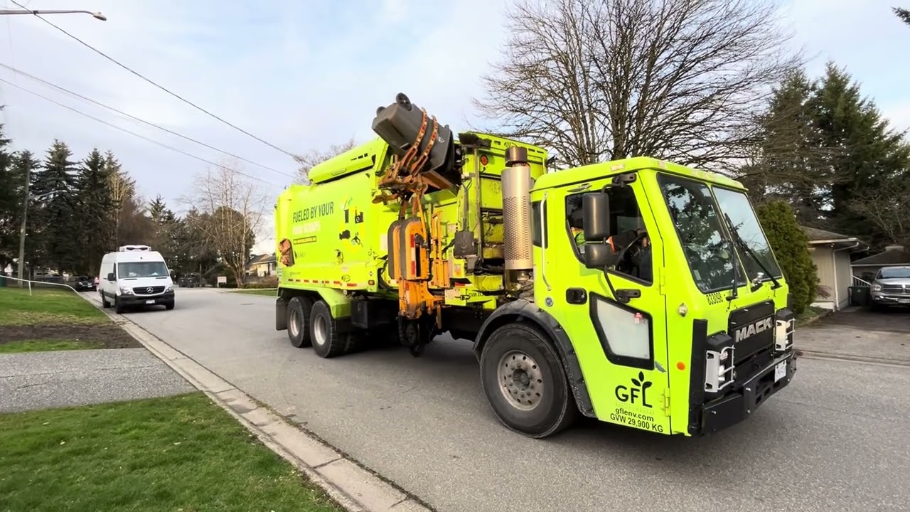2 GFL Mack LR garbage trucks on trash and greens.