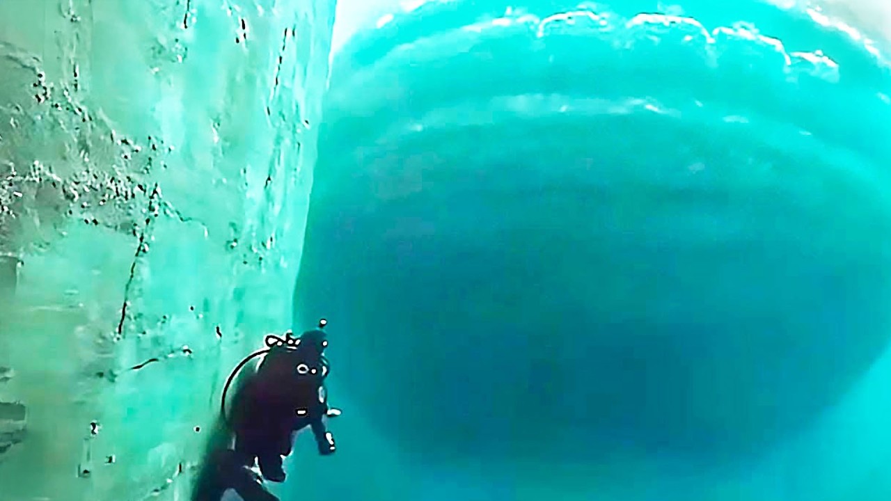 Underwater Camera Captures Massive Shape Passing Below Divers