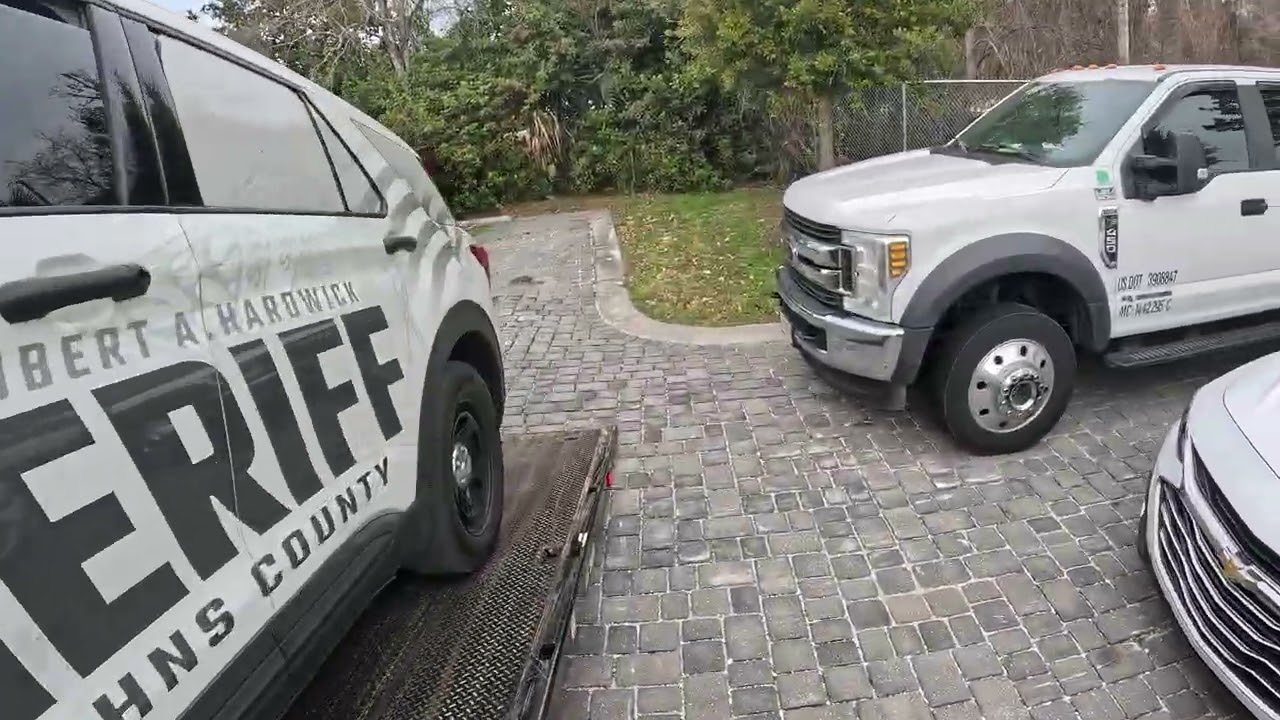 Towing in a broke down cop car dropping off at dealership 