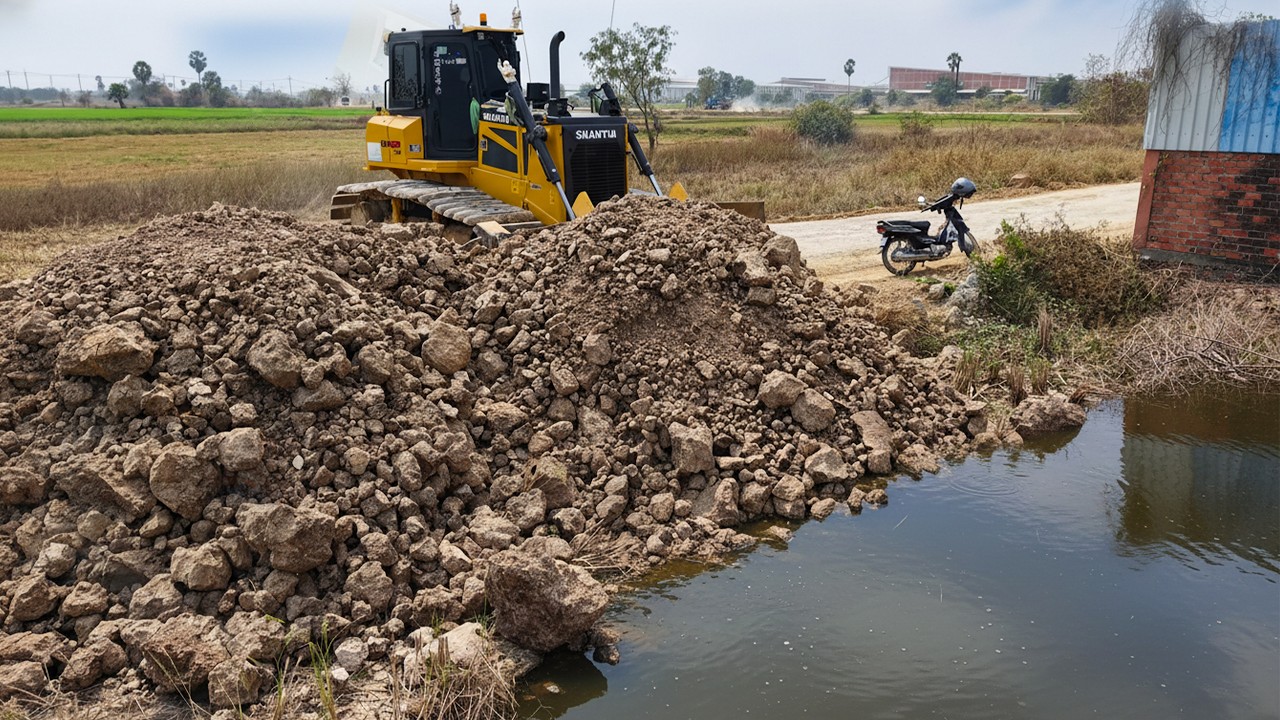 Construction Near Temple Fence  Dump Trucks Pour Soil & Dozers Push Stone