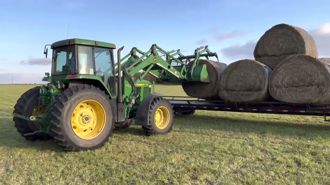 John Deere 7610 loading hay bales