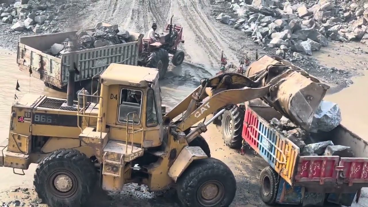 Powerful Caterpillar Loader Loading Giant Stones in Mountain Quarry
