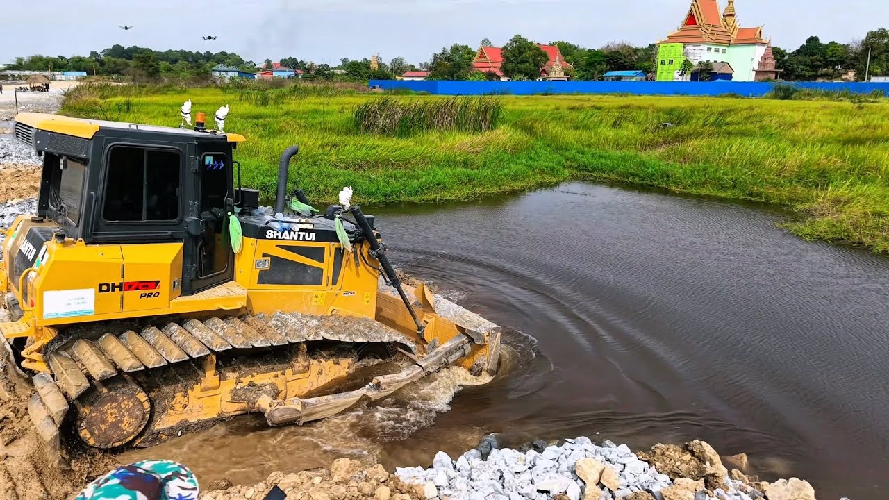 Smothly Dozer  Building Road Construction Over The Water Using Stones For Fill Clean Forest Pushing