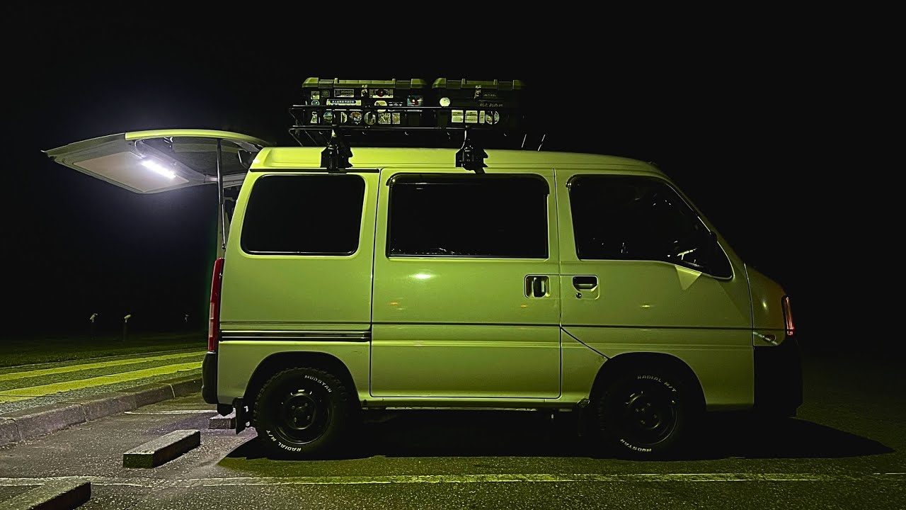 誰もいない静穏な海辺の駐車場でひっそり軽バンで車中泊する夫婦