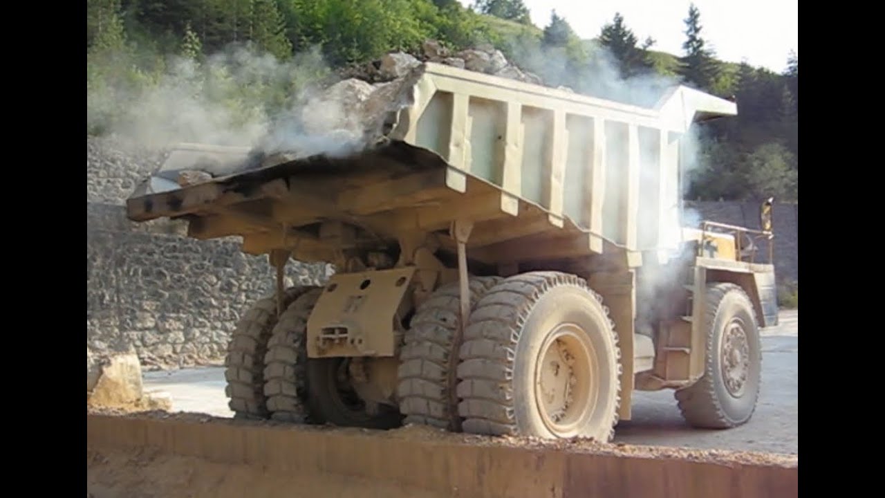 Big trucks carrying stones to the stone crusher plant