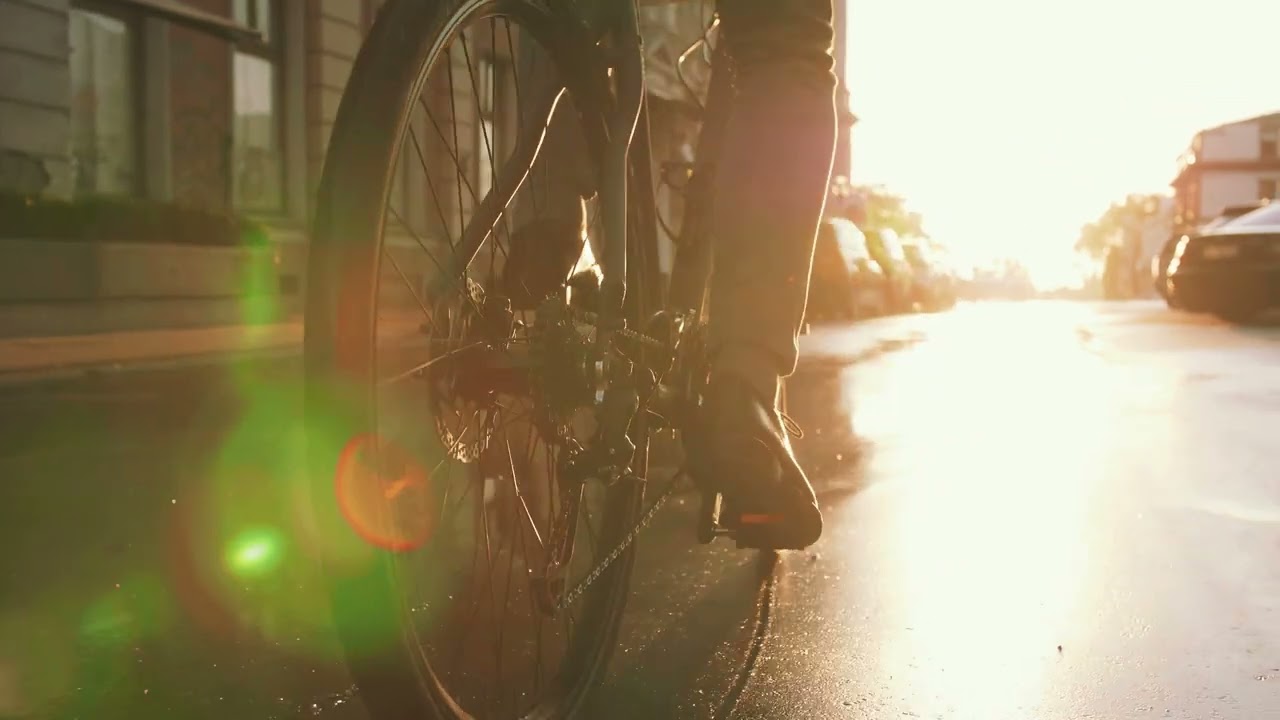 Close Up Shot Of Young Man Riding His Bicycle On The Street In City Center l HD l Footage l Free