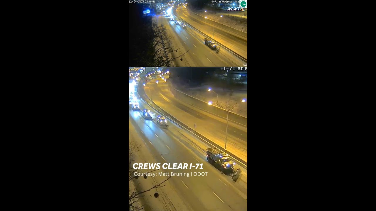 Snow plows work to clear snow off of I-71 in Cincinnati early Sunday morning