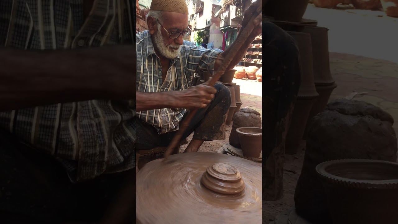 Potters village in Mumbai. Old Guy starting wheel