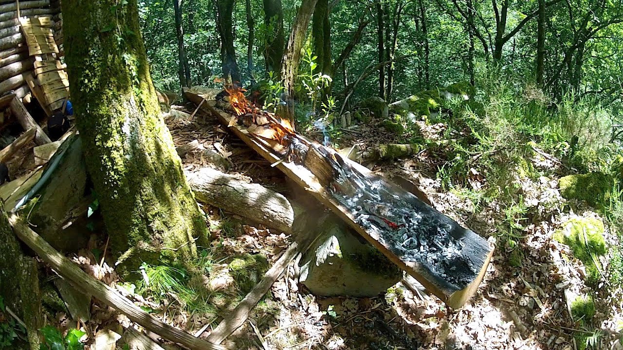 Fire-carved log as a cabin’s ridge cap
