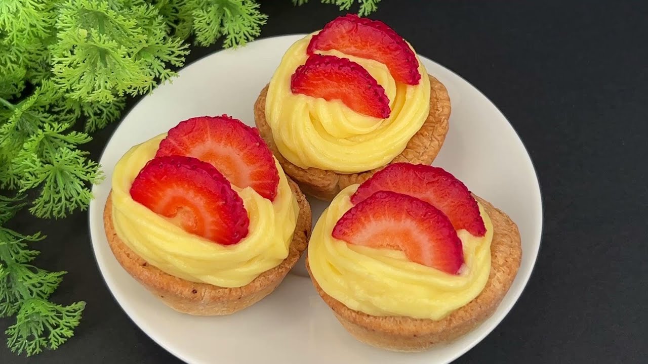 Mini puff pastry tartlets with strawberry jam and vanilla cream