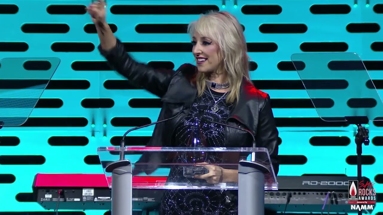 Britt Lightning accepts the Powerhouse Award at the She Rocks Awards