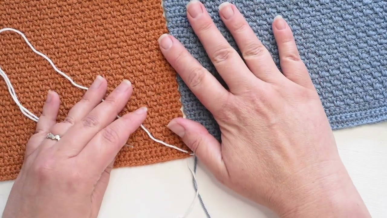 Sew crocheted squares together using mattress stitch to create a crisp join