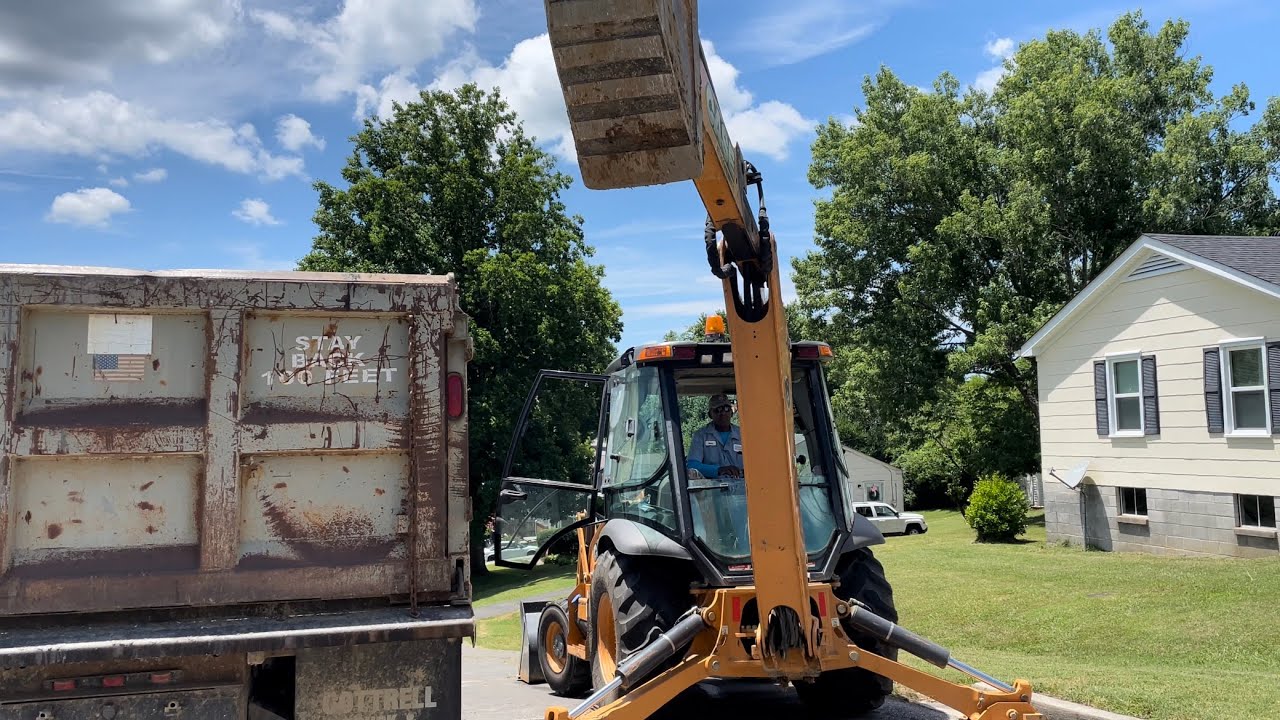 CASE Backhoe loading a dump truck road construction!