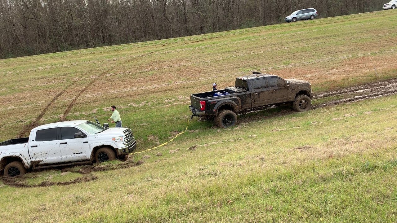 Ford Truck Pulls Brand New Toyota Tundra out of Rut || ViralHog