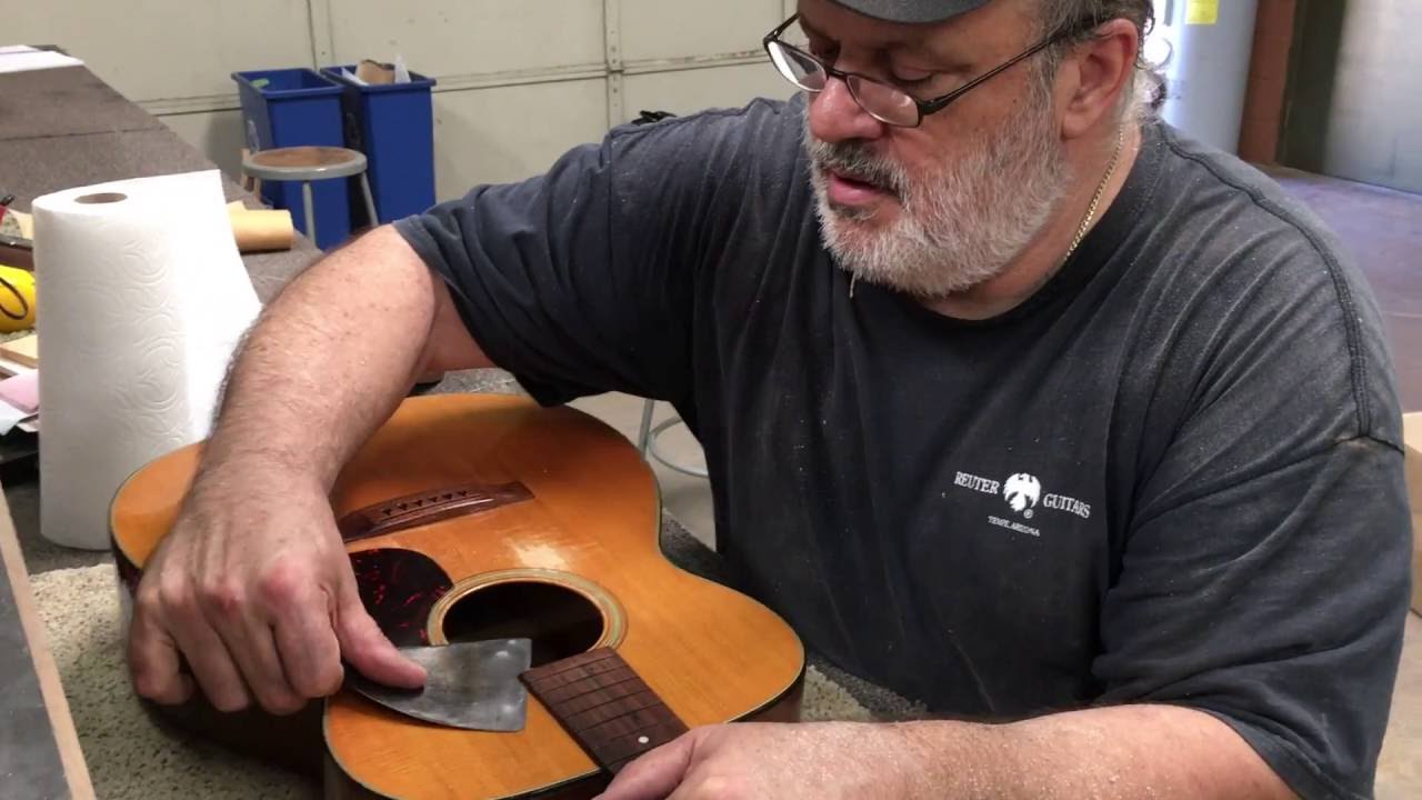 John Reuter removes the neck from a vintage Martin